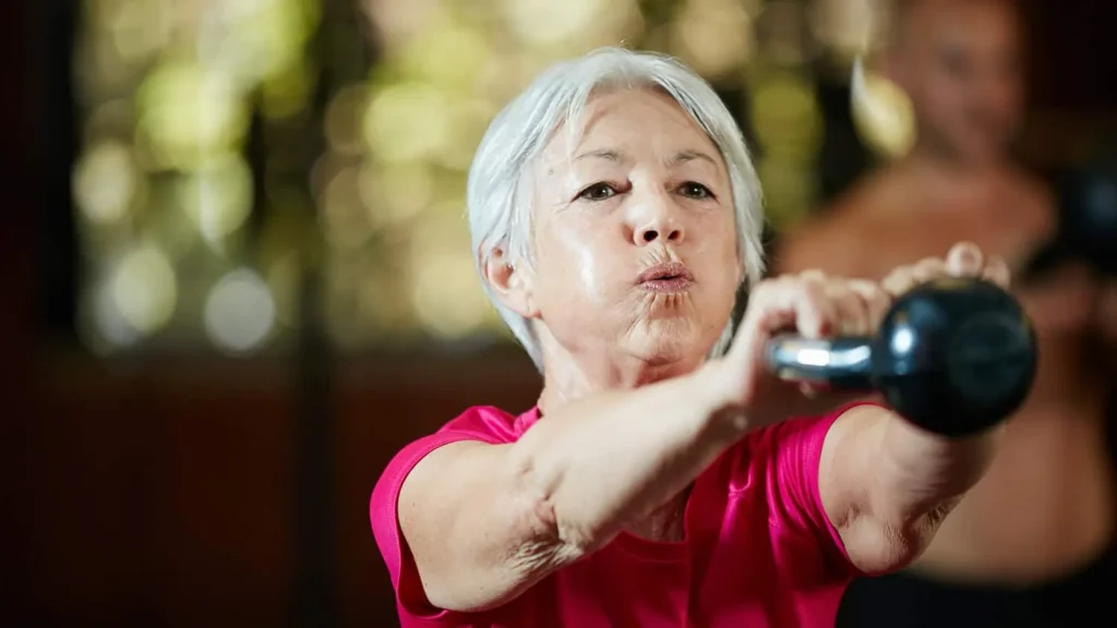 Toning Arms Without the Bulk: Is It Achievable? 1 Woman doing resistance band exercises for toned arms Lewes
